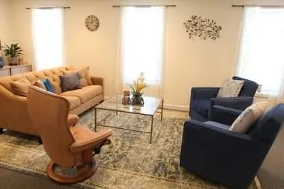 therapy room with cushioned chairs and a couch