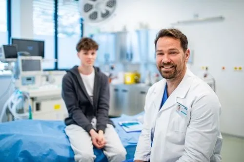 Doctor with a young man in the background on clinic