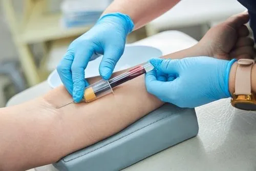 Physician performing blood draw for wellness testing on male patient