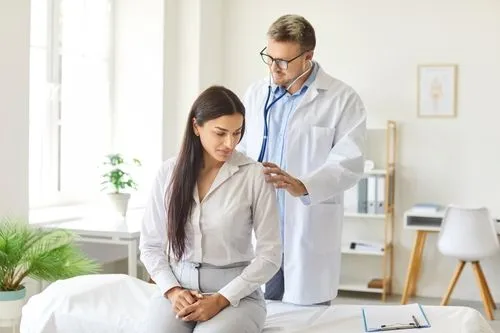 Female patient receiving a physical examination from doctor