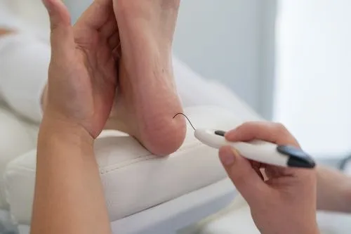 Podiatrist conducting a diabetic foot exam using a monofilament tool.