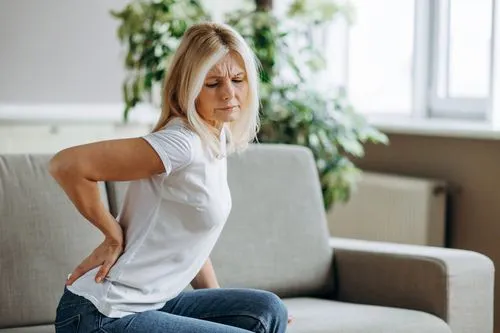 Woman suffers from lower back pain.