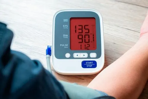Digital sphygmomanometer showing elevated blood pressure levels.