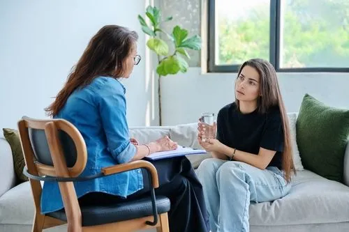 Young woman having talk to a therapist
