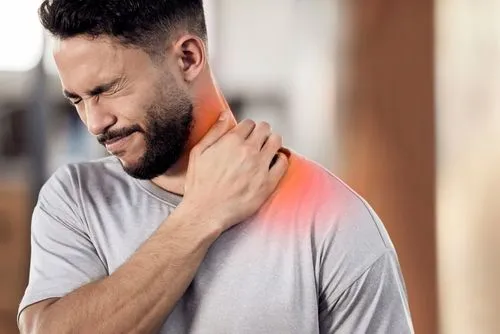 Man holding neck in pain due to muscle strain or injury