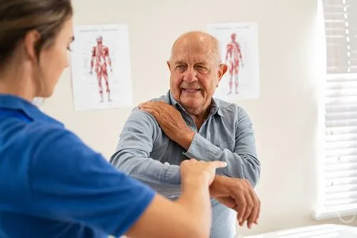 Elderly man consulting chiropractor for back pain relief in Ham Lake, Minnesota.