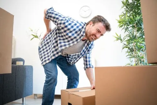 man with back pain due to lifting