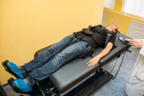Man receiving spinal decompression therapy at chiropractic clinic in Garden City, KS