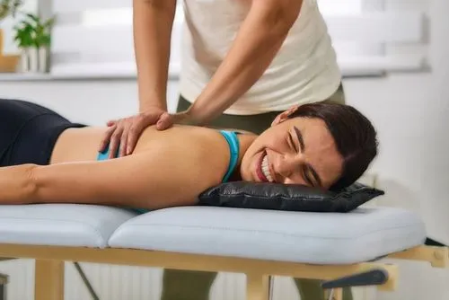Smiling woman receiving chiropractic treatment for chronic pain relief