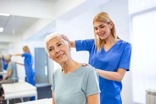 Senior female patient receiving chiropractic care for neck pain.