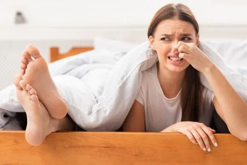 Woman feeling annoy in foot odor