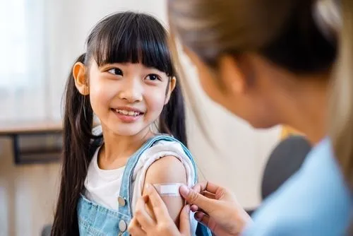 Smiling young girl after a flu immunization at a pediatric clinic