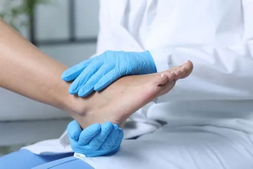 Podiatrist evaluating foot and ankle injury in patient