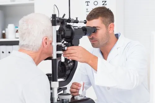 Eye specialist examining vision and eye health of elderly patient