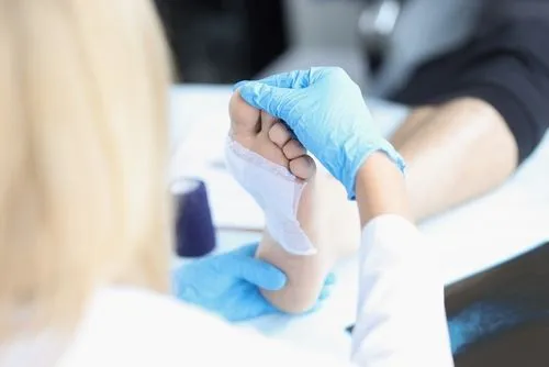 Podiatrist performing wound care on patient's foot