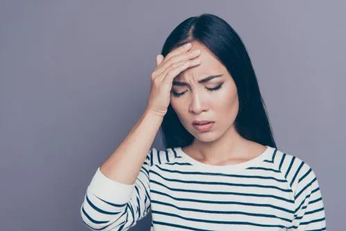 woman holding her head