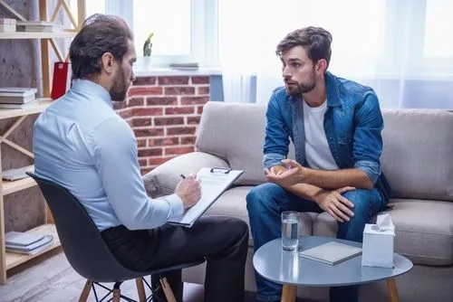 Male client receiving individual therapy in a professional setting