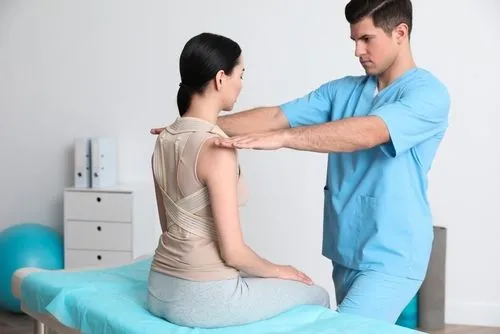 Female client receiving chiropractic posture correction