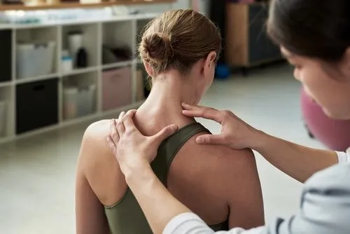 Doctor evaluating the back to make an adjustment on woman patient