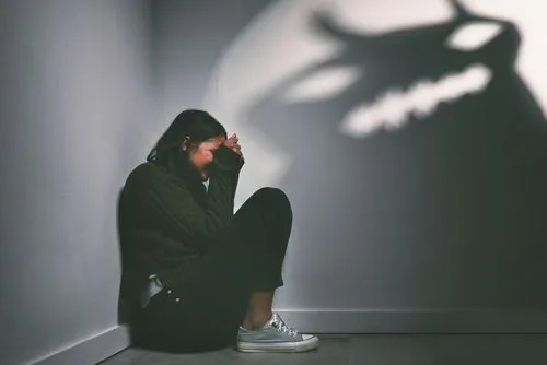 Woman feeling in fear with a monster shadow