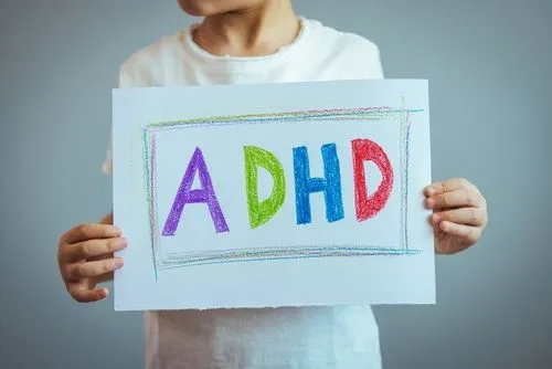 Pediatric ADHD awareness concept with child holding paper