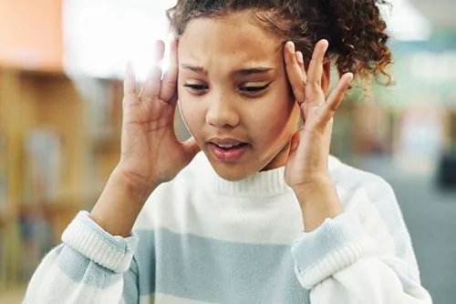 Young child experiencing headache discomfort