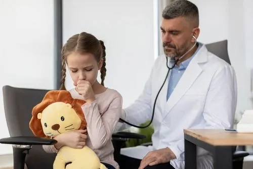 Child with cough being examined by pediatrician.
