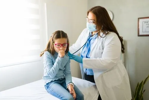 Young girl with cough check by the doctor on clinic
