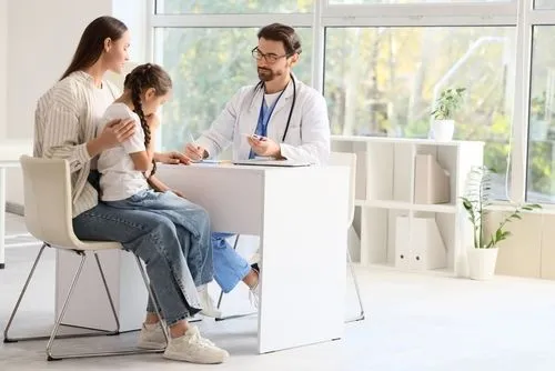 Mom with sick child during same-day appointment with pediatrician