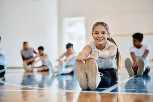 Cheerful kid enjoying PE class after passing a required school and sports physical