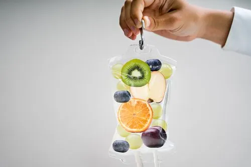 Medical professional showing saline bag for vitamin therapy