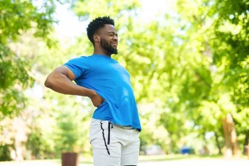 An athlete performing lower back stretches as part of a morning routine.