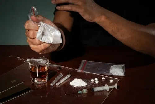 Person with druges on table