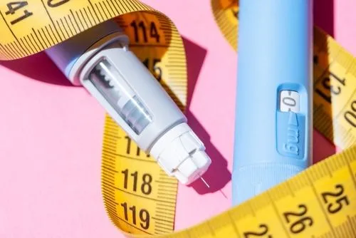 Close-up of Ozempic medication with a tape measure representing weight management.