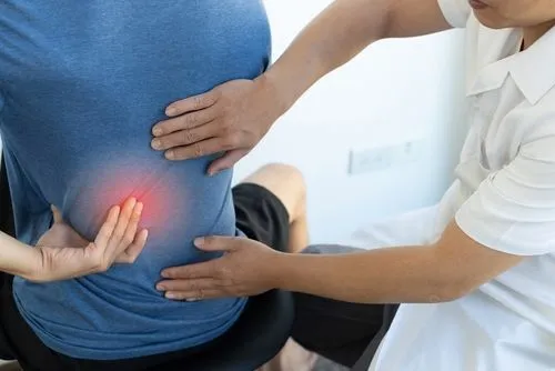 Chiropractor performing adjustment to reduce client's back pain