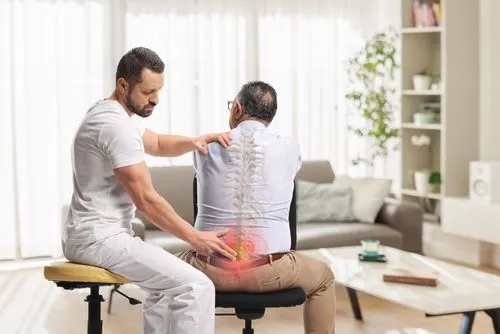 Chiropractor providing back pain treatment to a male patient