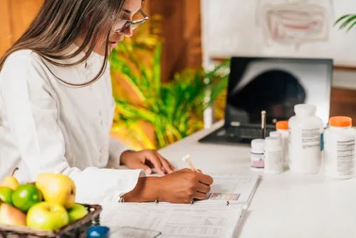 Female functional medicine doctor reviewing patient information at her desk