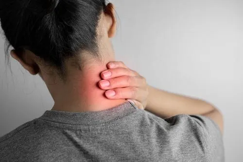 Female individual suffering from chronic or acute neck pain