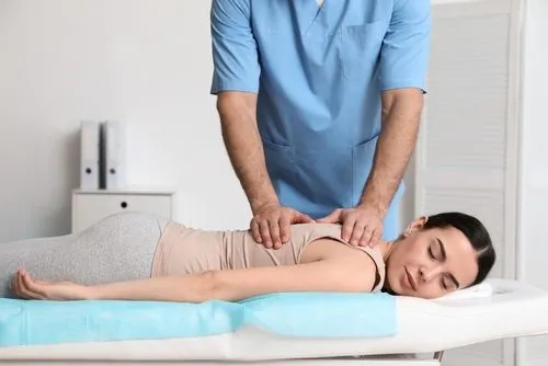 Female patient during cox flexion treatment with chiropractor