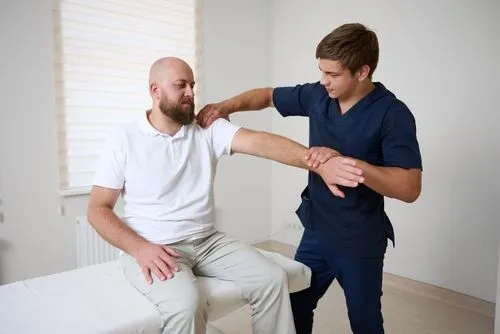Male patient receiving hands-on chiropractic care for shoulder issues.