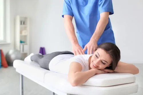 Female client receiving chiropractic treatment