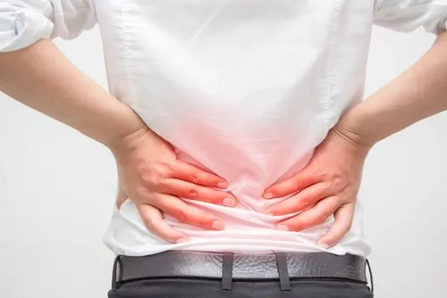 Man holding lower back in pain on white background
