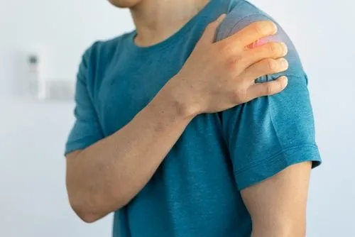 Man experiencing shoulder pain while at home