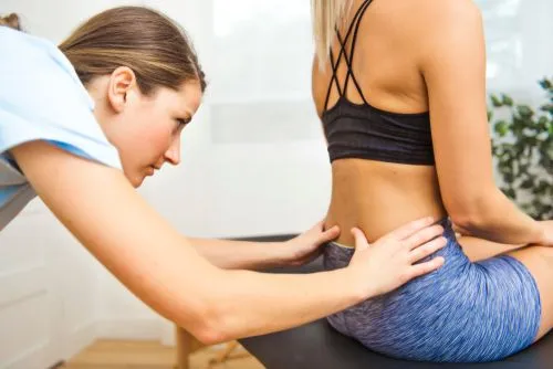 Chiropractor providing back pain treatment