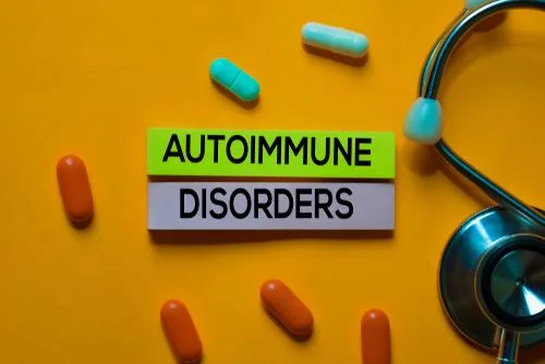 Autoimmune disorder text displayed with tablets and stethoscope