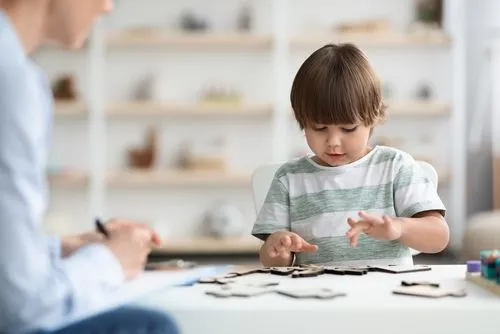 Therapist guiding child through therapeutic play session