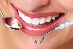 dental tools around woman's smiling mouth, nice teeth, cosmetic dentistry Westminster, MD cosmetic dentist