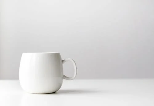 White Mug sitting on a table