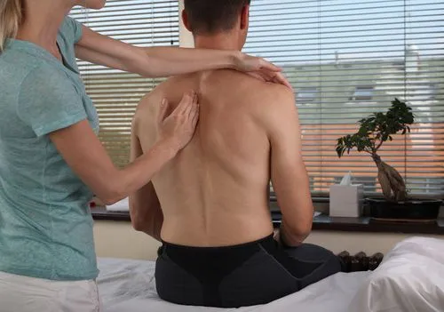 Man receiving a chiropractic adjustment from a chiropractor