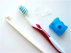 toothbrush and floss on white surface, dentist Wauwatosa, WI